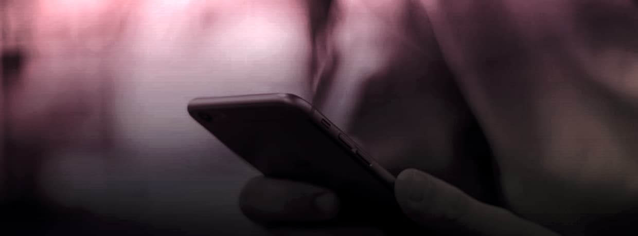A hand holding a smartphone with the screen in view, illustrating in-platform search
