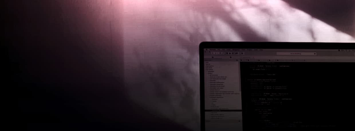 An open laptop in a darkened room, illustrating the anonymous scraper sites discussed here