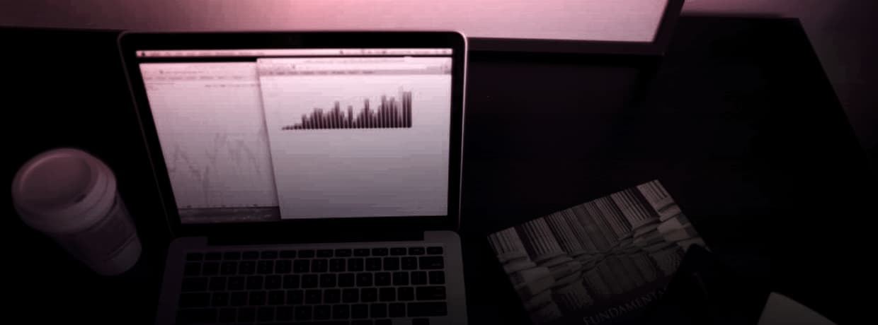 Printed charts and comparison tables spread across a desk