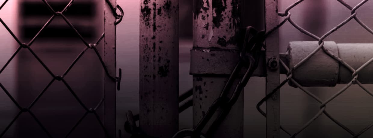A chain-link gate secured with a padlock and chain, illustrating account security